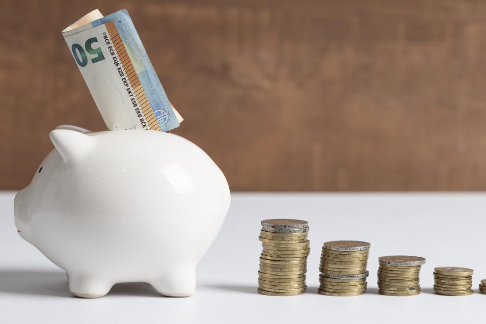 side-view-piggy-bank-with-coins-banknotes