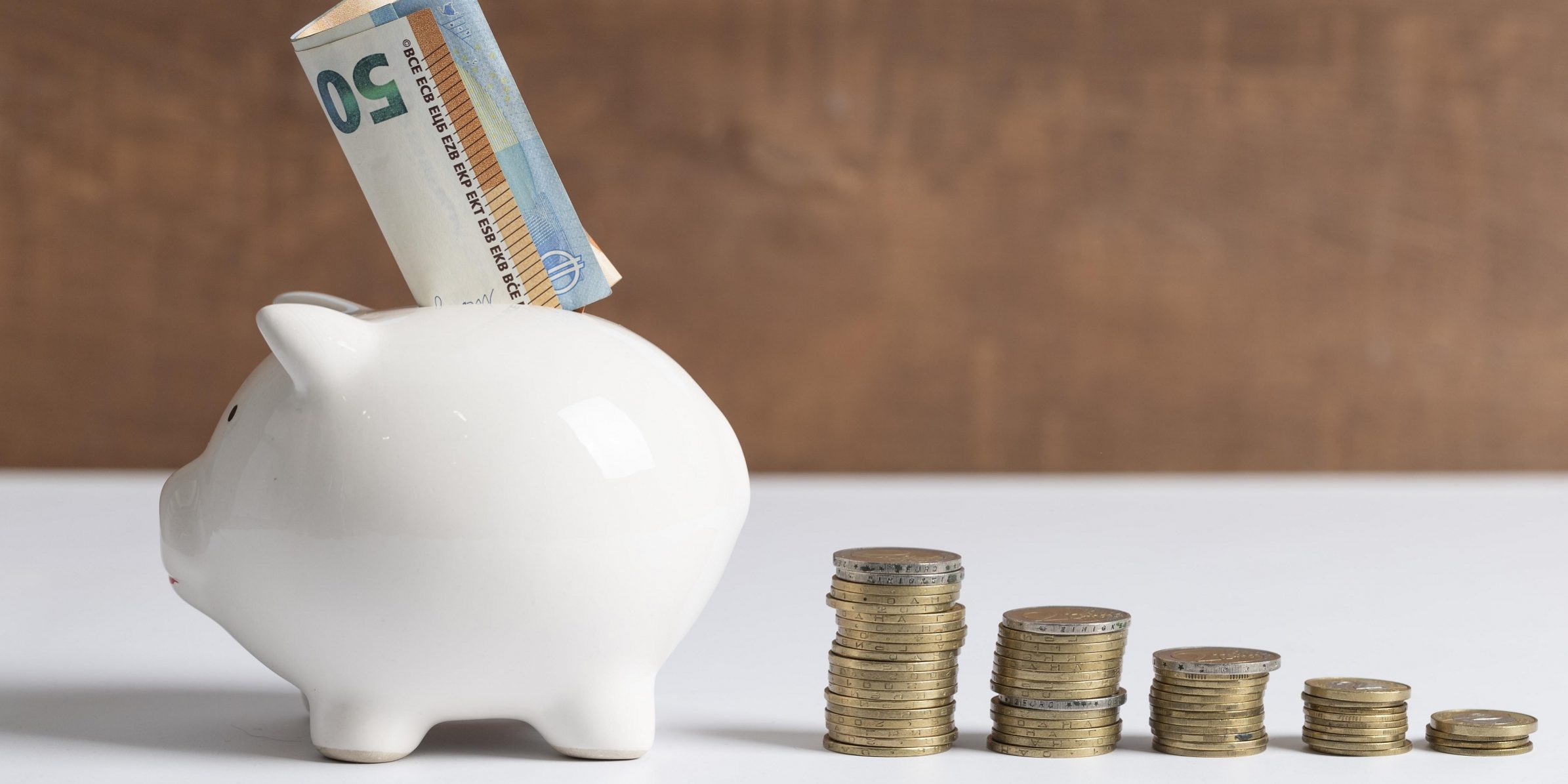 side-view-piggy-bank-with-coins-banknotes
